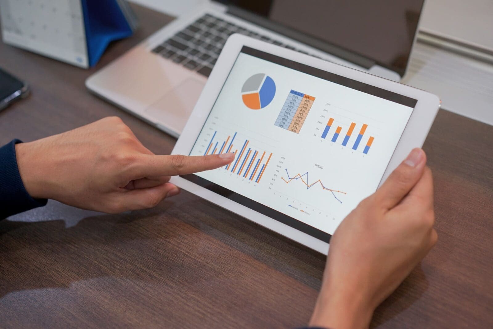 Woman pointing to a performance dashboard. Credit: https://www.istockphoto.com/portfolio/ChainarongPrasertthai?mediatype=photography