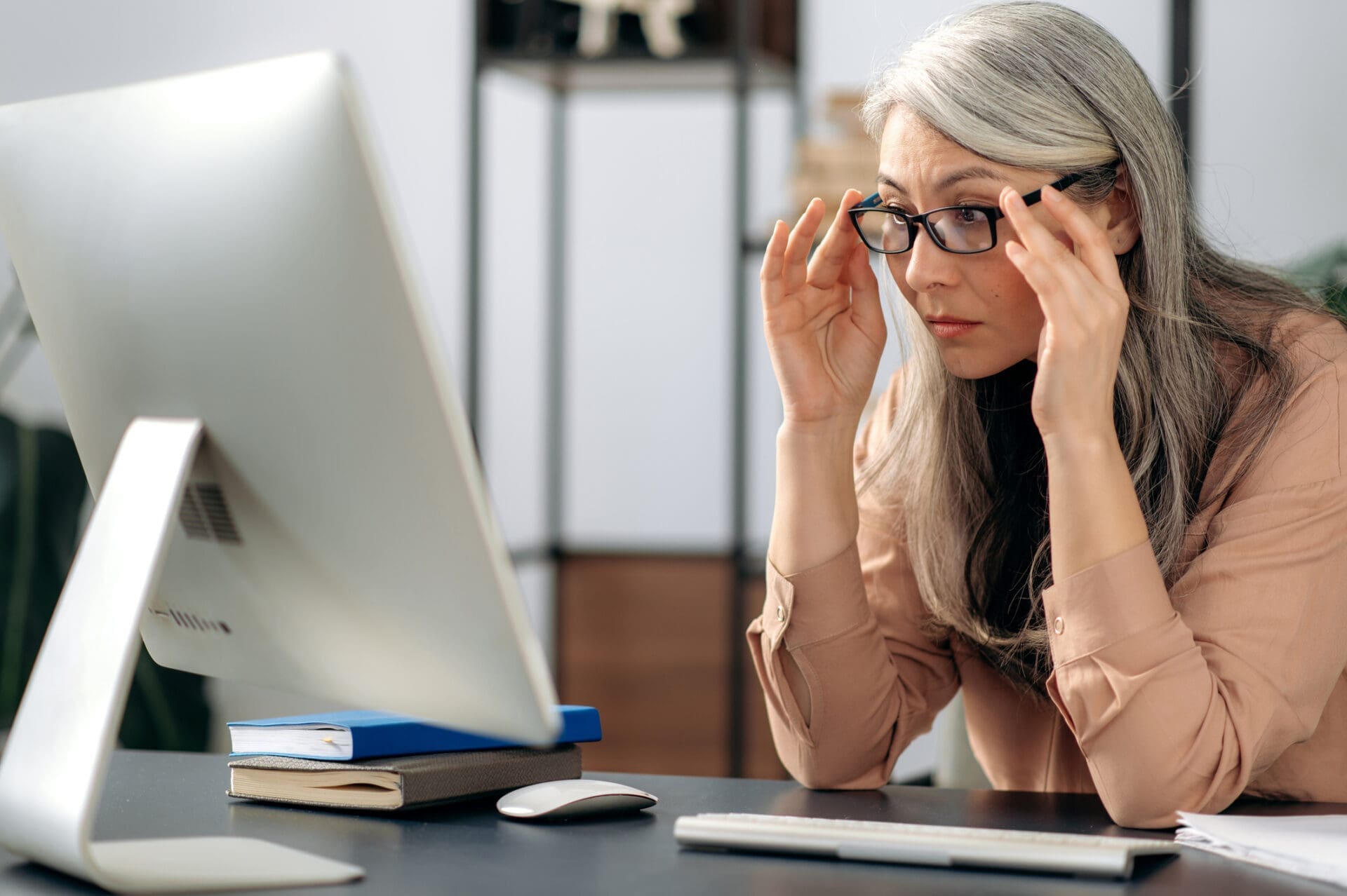 Mature Asian woman works at a computer to build an XmR chart. CREDIT: https://www.istockphoto.com/portfolio/KaterynaOnyshchuk
