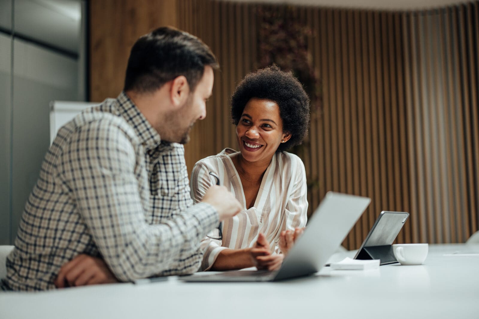 A female with a male colleague watching a webcast. CREDIT: https://www.istockphoto.com/portfolio/nortonrsx