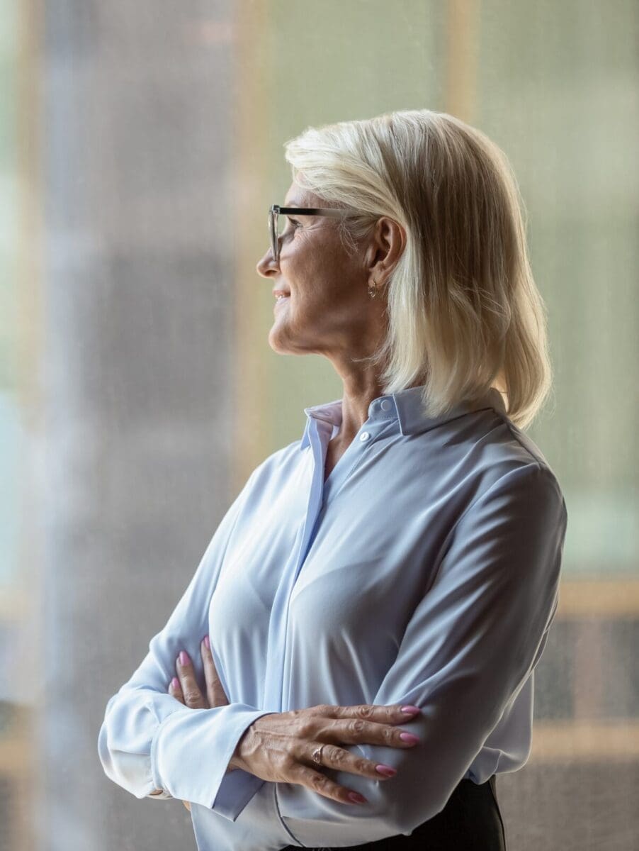 Middle-aged businesswoman look in distance thinking or visualizing. CREDIT: https://www.istockphoto.com/portfolio/fizkes