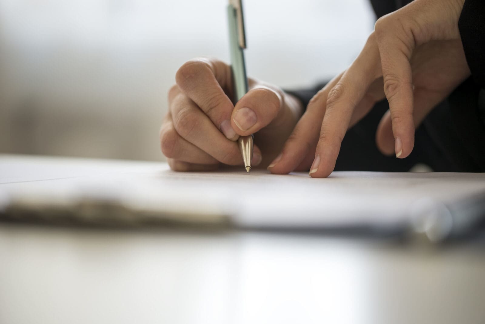 Hands of a person writing on a notepad. CREDIT: https://www.istockphoto.com/portfolio/Gajus